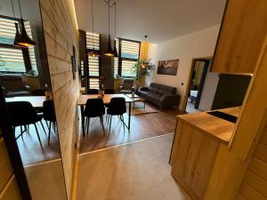 a living room and dining room with a table and chairs at Flora Hotel Apartment 103 in Borovets