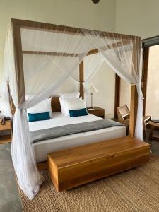 een slaapkamer met een hemelbed bij The Coast Sri Lanka, Bentota in Bentota +62 foto's