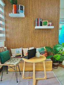 a living room with a table with a laptop on it at The Cozy Canopy in San Fernando