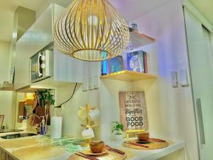 a kitchen with a chandelier and a table with baskets at The Cozy Canopy in San Fernando