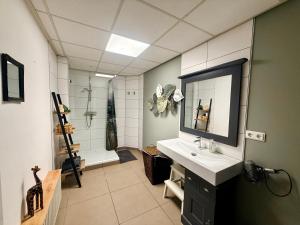 a bathroom with a sink and a shower at Kom tot rust in The Forest in Putte +60 photos