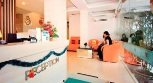 two people sitting in a lobby of a store at Graha Cempaka Boutique Hotel in Surabaya