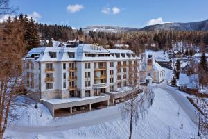 an aerial view of a building in the snow at Palace Apartments in Špindlerův Mlýn