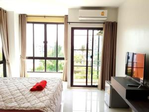 a bedroom with a bed with a red pillow on it at THE ALL 24 Luxury Residence in Bangkok +59 photos