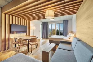 a living room with a couch and a table at Palace Apartments in Špindlerův Mlýn