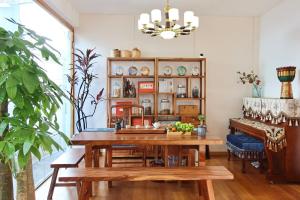 a dining room with a table and a piano at 大理六悦客栈Dali Liuyue Inn in Dali