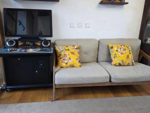 a couch with two pillows sitting in a living room at 大理六悦客栈Dali Liuyue Inn in Dali +29 photos