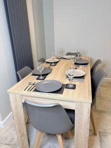 een houten tafel met stoelen en wijnglazen erop bij The Old Pitman's house in Ollerton +13 foto's