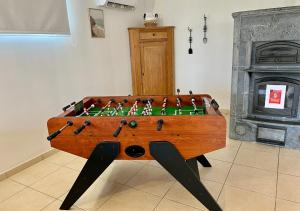 a foosball table in a living room with a fireplace at L'abreuvoir de la Mer- villa - plage in Sangatte