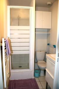 a bathroom with a toilet and a glass shower at La Colombière - Montélimar in Montélimar