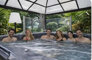een groep mensen in een jacuzzi bij L'écrin de bois -sauna - spa in Mur-de-Bretagne