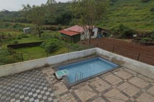 an overhead view of a swimming pool on a patio at Saachi Villa in Panchgani