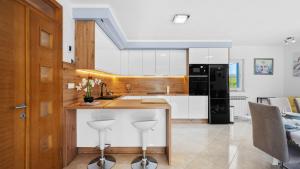 a kitchen with a counter with stools in it at Villa Pleter by Villas Guide in Ružić