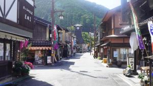 an empty street in a mountain town with buildings at Base House Kinosaki - Vacation STAY 68122v in Tsuiyama