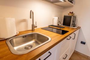 a kitchen counter with a sink and a microwave at Agriturismo La Querciola in Riolo Terme +74 photos