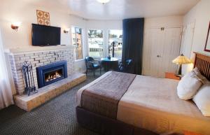 a hotel room with a bed and a fireplace at Capitola Venetian Vacation Rentals in Capitola