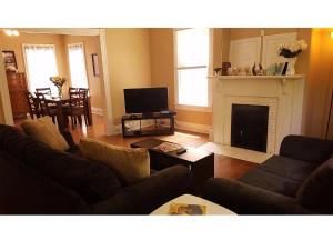 a living room with a couch and a fireplace at The B in Louisville