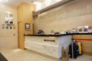 a reception area of a hotel with a reception counter at H1 Hotel in Hong Kong