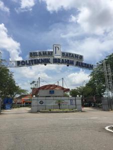a sign for a park in a parking lot at Tey Hotel in Pasir Gudang