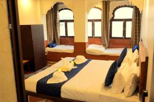 a bedroom with a bed with hats on it at The Lake Haveli in Udaipur +7 photos