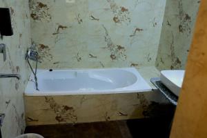 a bathroom with a bath tub and a sink at The Lake Haveli in Udaipur