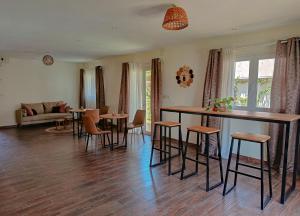 a living room with a bar and some chairs at Maison Hely Tiana in Antananarivo +16 photos