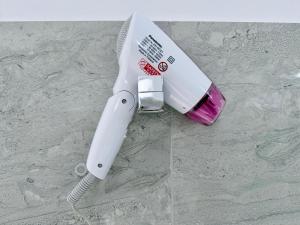 a white electric toothbrush sitting on top of a counter at Turtle Bay Resort Hikkaduwa in Hikkaduwa