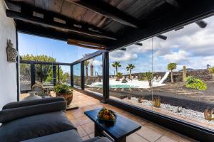 a living room with a view of the ocean at La Geria Suites in Yaiza