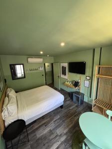 a bedroom with a bed and a desk and a table at Hotel de Berne in Nice