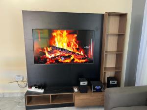a flat screen tv sitting in front of a fire at Goodlifehomes in Mtwapa