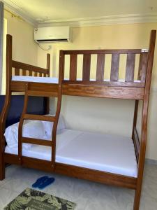 two bunk beds sitting in a room with a rug at Goodlifehomes in Mtwapa