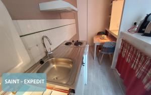 a kitchen with a sink in a small room at Bernadette' Cosy Flat - 3 minutes walk main door to sanctuary entrance- Old Town - Bernadette de Soubirous's neighborhood - Chapel for Prayer on site in Lourdes