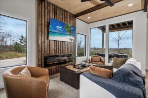 a living room with two couches and a tv at *Rooftop Deck*Hot Tub*Sauna*Fire Pit*Sunset Views* in Campton