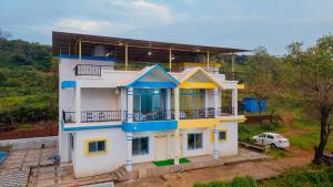a house with blue and yellow paint on it at Saachi Villa in Panchgani