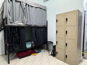 a room with two lockers and a bunk bed at Bed space for Budget Backpacker - No Parking in Abu Dhabi