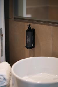 a soap dispenser on the wall of a bathroom at Garden Double Suite - 3 min walk to Bernina Express in Tirano +5 photos
