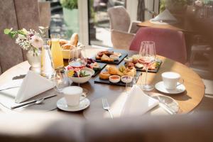 a table with plates of food and drinks on it at Hotel Schachner in Maria Taferl