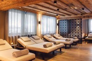 a room with a bunch of beds and windows at Das Liebener 4 Sterne Superior - ADULTS ONLY! in Obergurgl