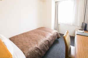 Postel nebo postele na pokoji v ubytování Hotel Sunroute Tochigi