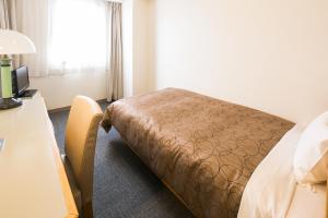 Postel nebo postele na pokoji v ubytování Hotel Sunroute Tochigi