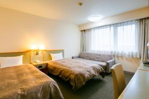 Postel nebo postele na pokoji v ubytování Hotel Sunroute Tochigi