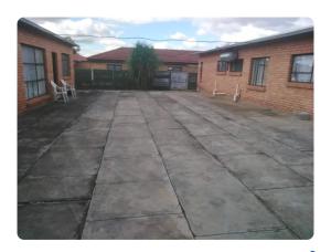 an empty courtyard in front of a brick building at VSA SELF CATERING unit 1 in Newcastle