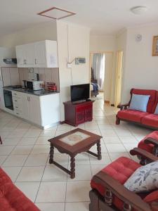 a living room with a couch and a table at VSA SELF CATERING unit 1 in Newcastle