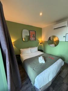 a bedroom with a bed with two towels on it at Hotel de Berne in Nice +109 photos