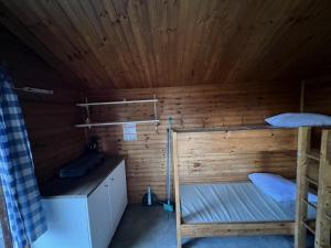 a bedroom with two bunk beds in a wooden room at Camping Suderse - De Protter in Workum