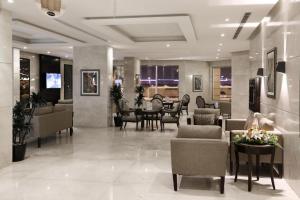 a lobby with chairs and a table in a building at سدو بوتيك الخبر in Al Khobar