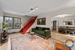 ein Wohnzimmer mit einem grünen Sofa und einer roten Treppe in der Unterkunft Peaceful Lake Como Retreat in Lake Como