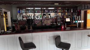 a bar with two chairs in front of it at The March Hotel in March