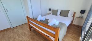 a bedroom with a bed with white sheets and pillows at Skyline Villas RC in Arco da Calheta