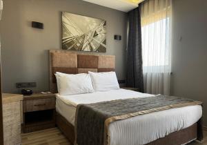 Ένα ή περισσότερα κρεβάτια σε δωμάτιο στο Ankara Royal Hotel